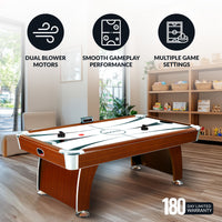 Air hockey table with features highlighted in a room setting